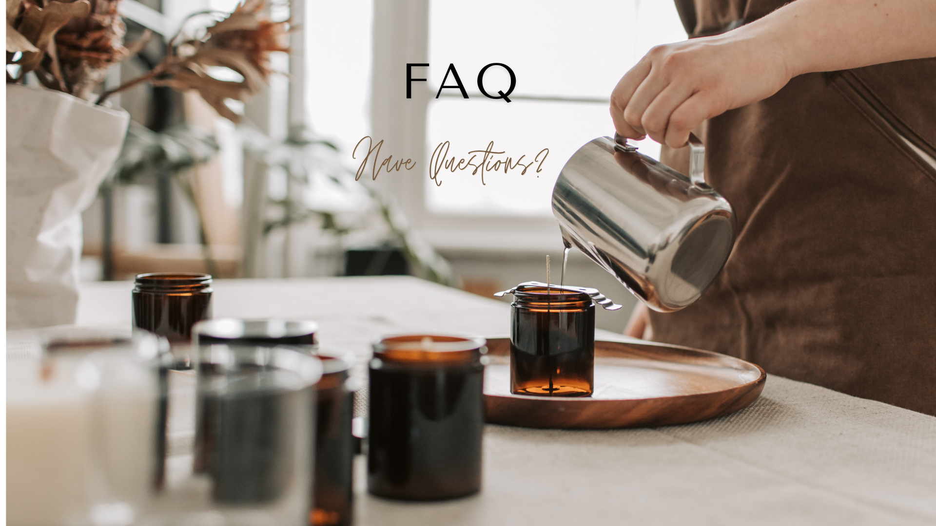 A person in a brown apron pours liquid from a stainless steel pitcher into an amber glass jar on a wooden tray, with other glass jars arranged on a table in a softly lit indoor setting. The text 'FAQ' and 'Have questions?' appears over the scene.