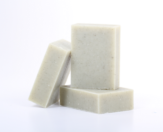 Three bars of eucalyptus soap stacked on a white background