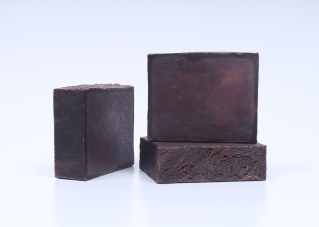 Three bars of dark vanilla soap on a white background