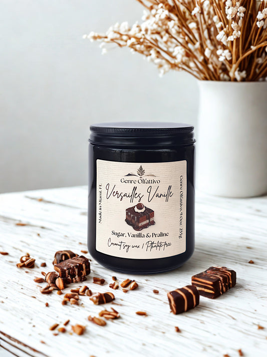 Candle jar with a label on a wooden surface with chocolate candies and vanilla beans.