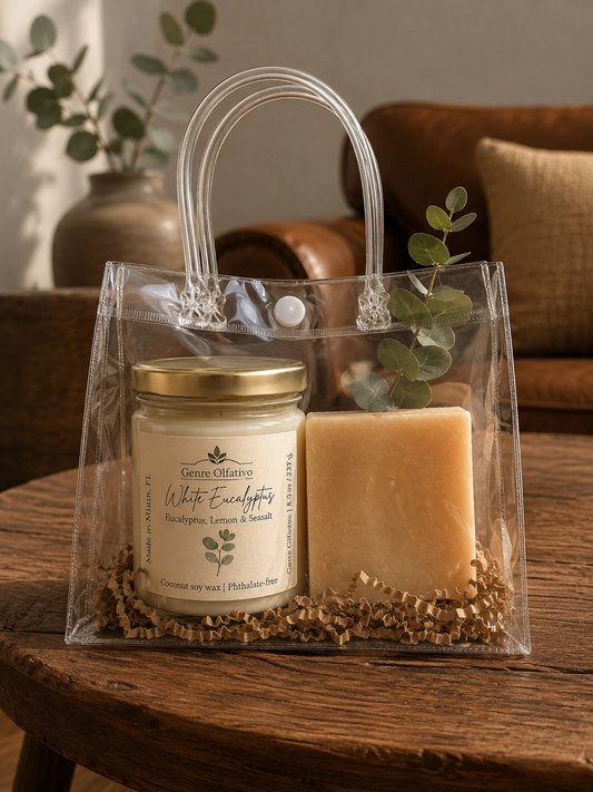Clear gift bag with a eucalyptus candle and soap on a wooden surface, with a blurred indoor background.